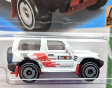 Load image into Gallery viewer, Hot Wheels 2023 Mitsubishi Pajero Evolution White #175 Mud Studs 3/5 New Long Card