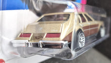 Load image into Gallery viewer, Hot Wheels 2023 '82 Cadillac Seville Gold #75 HW: The '80s 7/10 New