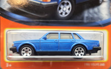 Load image into Gallery viewer, Matchbox 2023 1986 Volvo 240 Maroon Light Blue #99 MBX Showroom New Long Card

