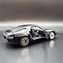 Load image into Gallery viewer, Welly 1982 Porsche 928 Dark Blue/Black #110 1:64 Car
