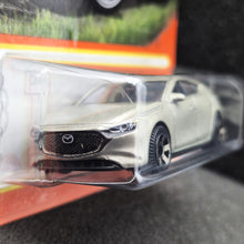 Load image into Gallery viewer, Matchbox 2024 2019 Mazda 3 Champagne #77 MBX Roadtrip New Long Card
