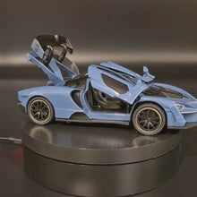 Load and play video in Gallery viewer, Explorafind 2019 McLaren Senna Blue/Grey 1:32 Die Cast Car